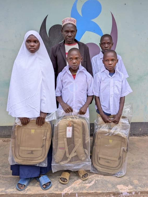 Father and children with school backpacks